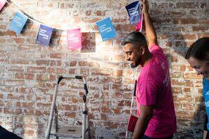 A picture of someone putting up Cancer Research UK bunting