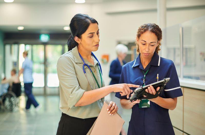 Dr and a nurse talking together