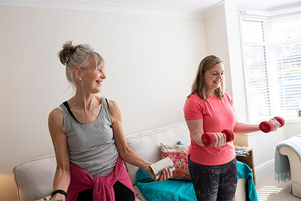 Two women working out together smiling