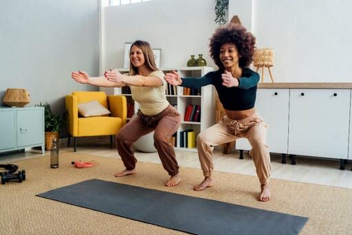 Two women squatting in living room