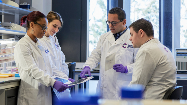 Image of researchers talking to each other in a lab