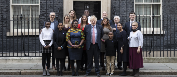 CRUK volunteers and Prime Minister standing outiside 10 Downing Street