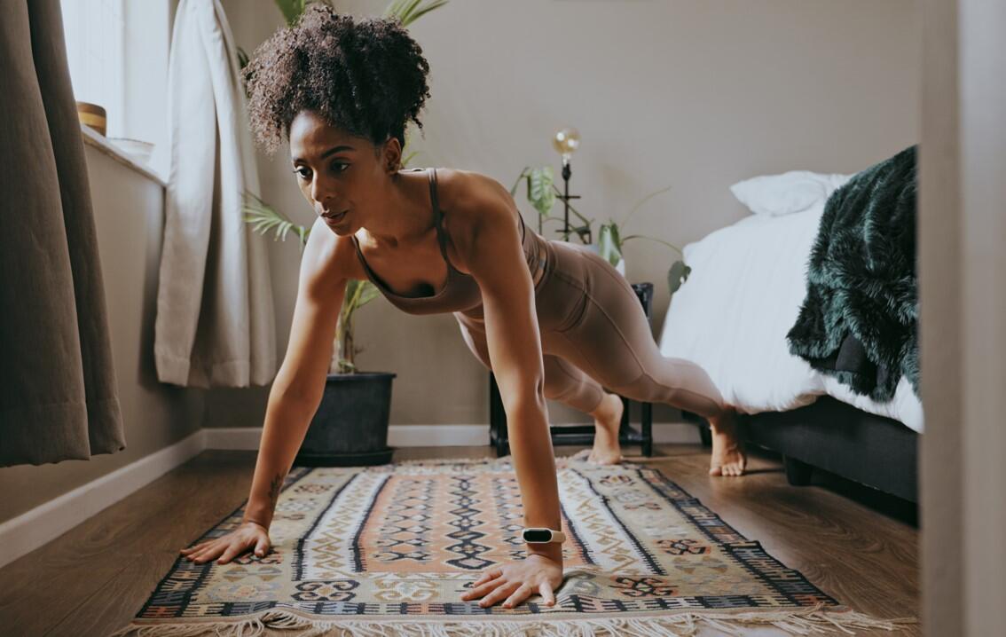 Women doing push-ups in her bedroom